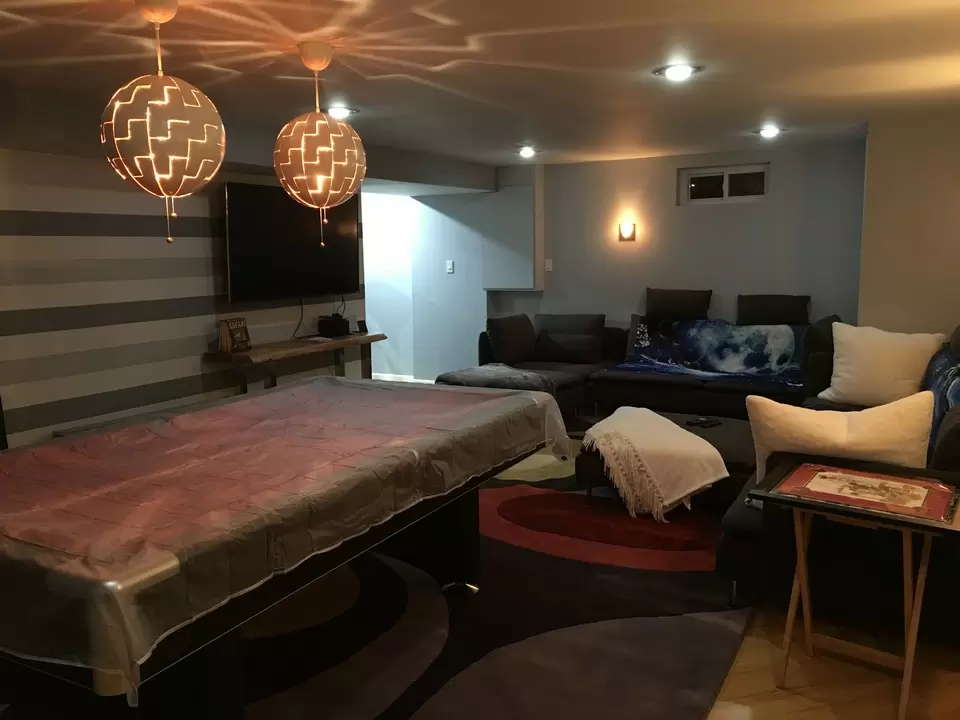 A basement that we have remodeled featuring a couch and pool table